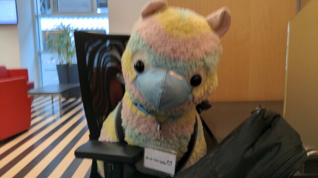 A giant alpaca horse on an office chair in a DB Lounge.